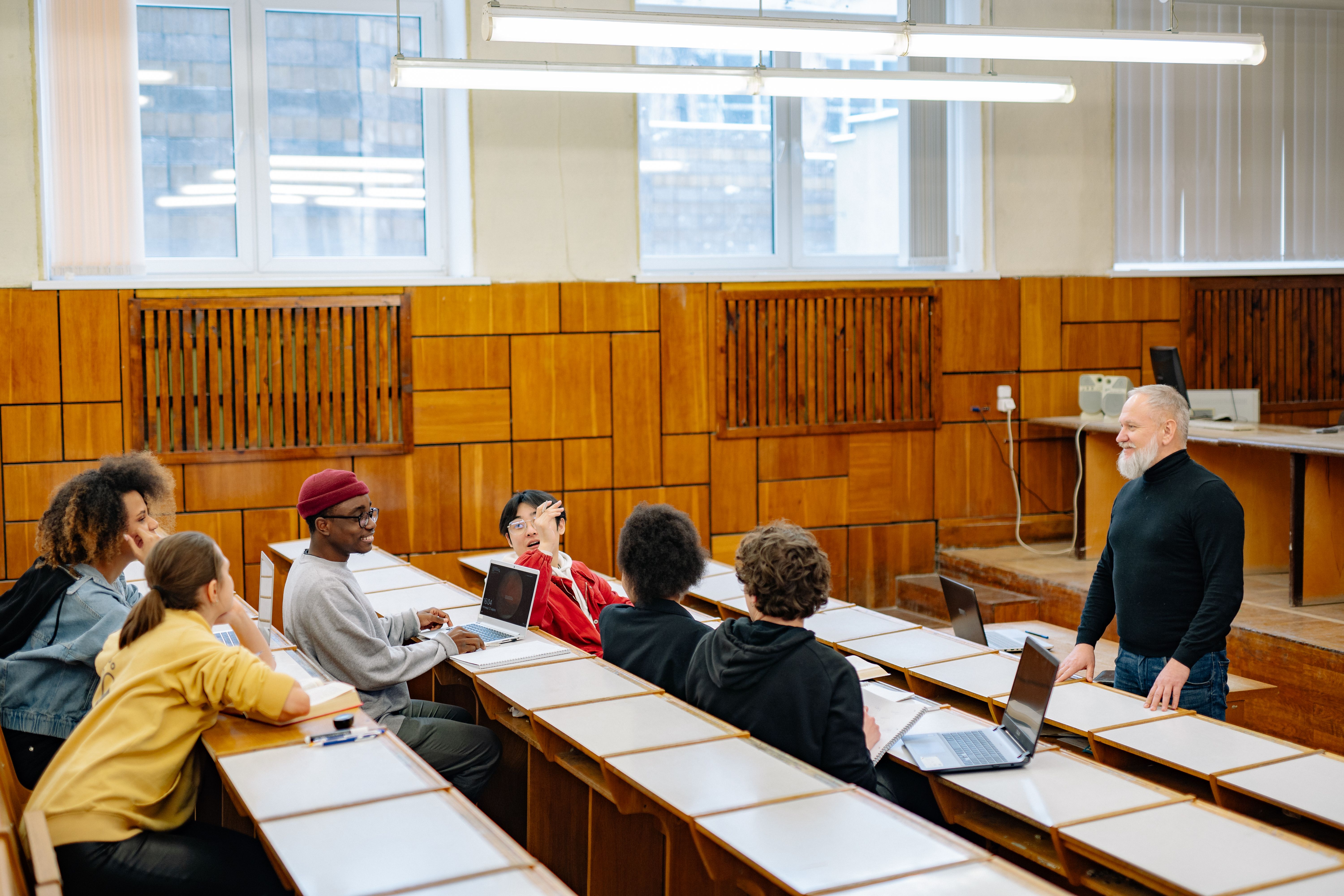 University students in a classroom engaging in discussion with their professor